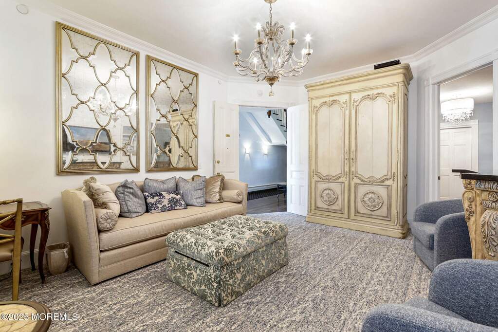Double door entrance to suite, large sofa and ottoman.