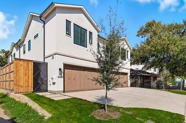 View of front of house with an attached garage, brick siding, concrete driveway, and stucco siding