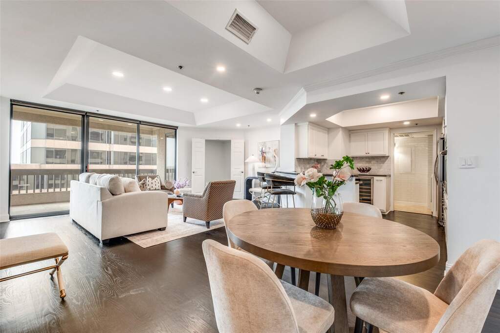 Experience a seamless flow between the chef-inspired kitchen and the expansive living room. Highlights include recessed LED lighting, tray ceilings, and a massive sliding glass door that lead