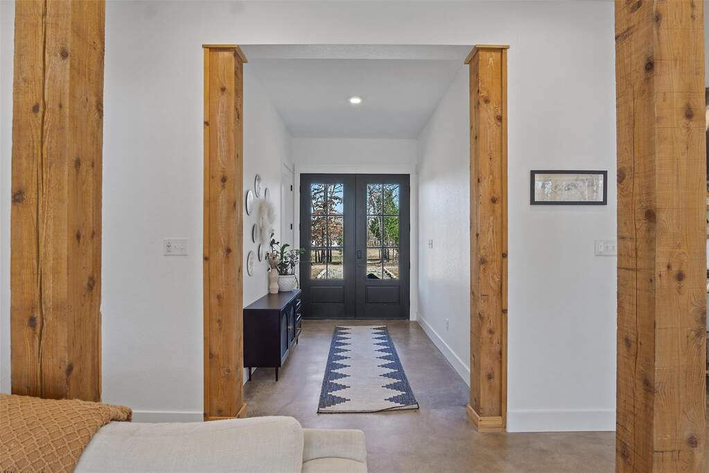 Entrance foyer featuring french doors, finished concrete flooring, and recessed lighting