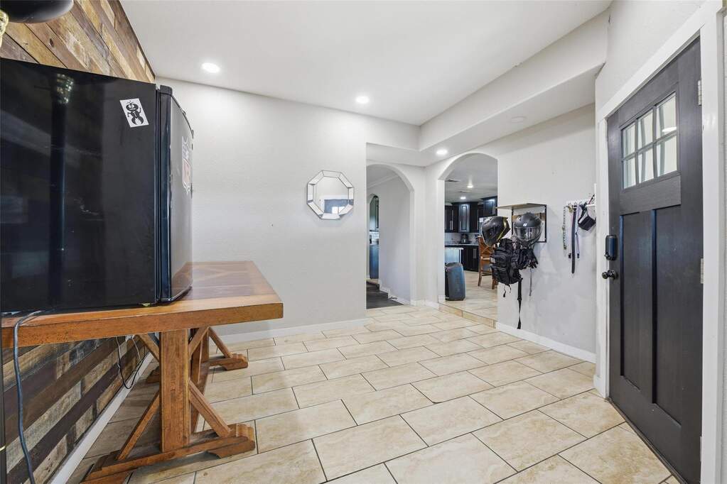 Entrance foyer featuring arched walkways, recessed lighting, and light tile patterned flooring