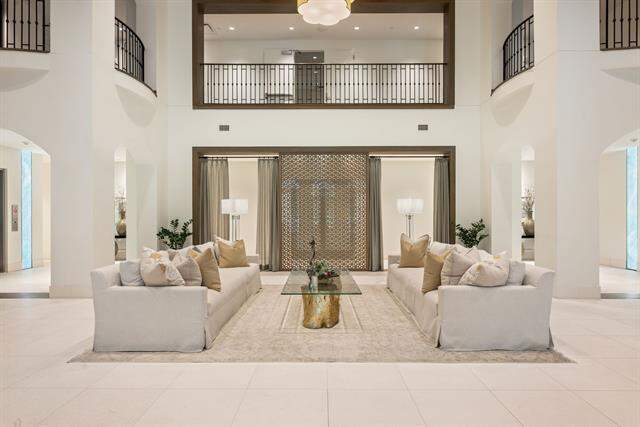 Building lobby area featuring arched walkways and a high ceiling