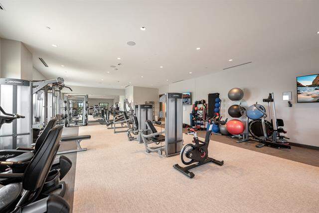 Workout area featuring recessed lighting and light colored carpet
