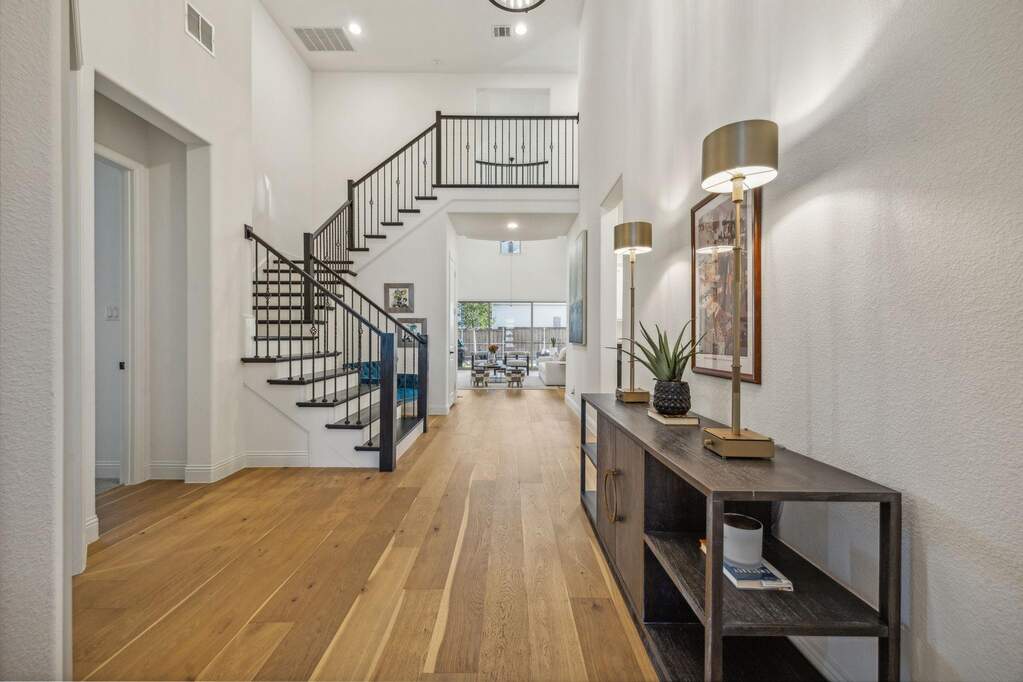 Foyer entrance featuring light hardwood / wood-style floors and a high ceiling