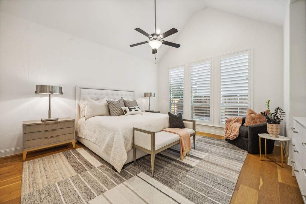 Bedroom with hardwood / wood-style flooring, ceiling fan, and vaulted ceiling
