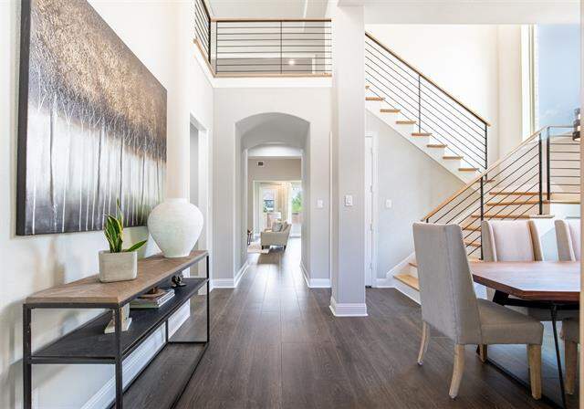 Beautiful two story entryway with modern slated staircase