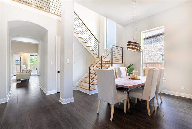 Lovely dining room with tall ceilings and decorative lighting