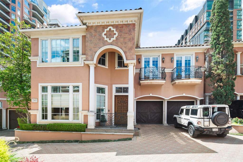 The property features an architectural style with a stucco exterior finish and decorative stone accents