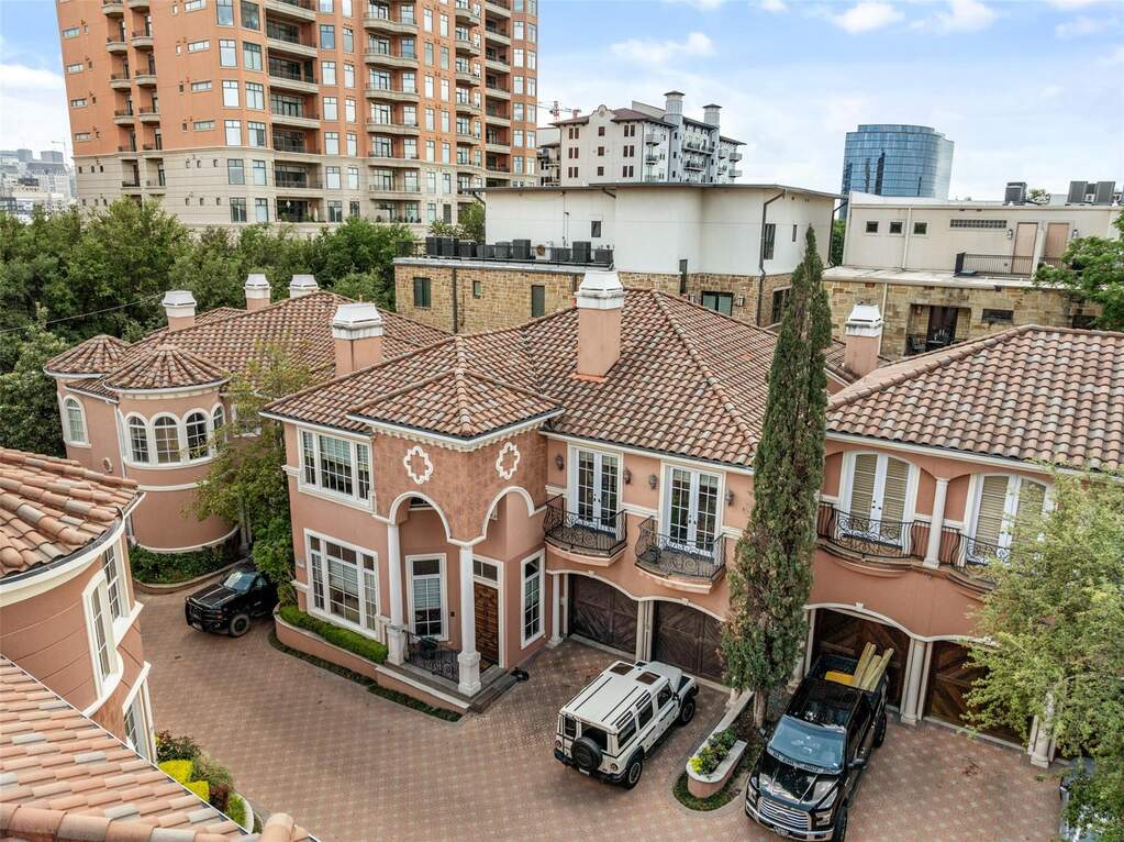 This property features a terracotta-tiled roof, a stucco exterior, and arched windows