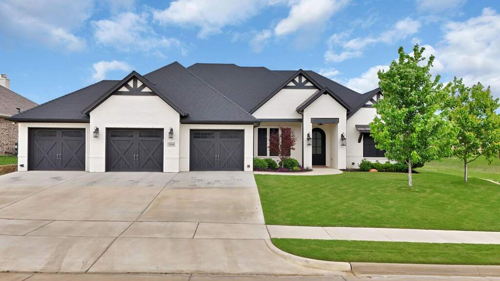 View of front of house featuring a garage and front yard