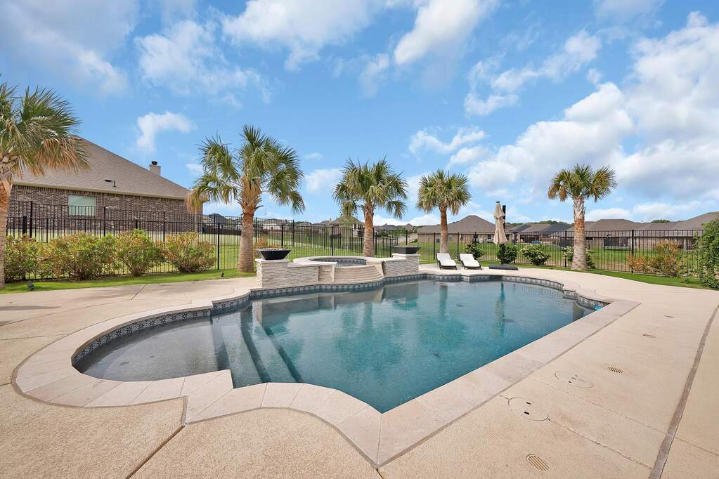 View of pool with an in ground hot tub and a patio area
