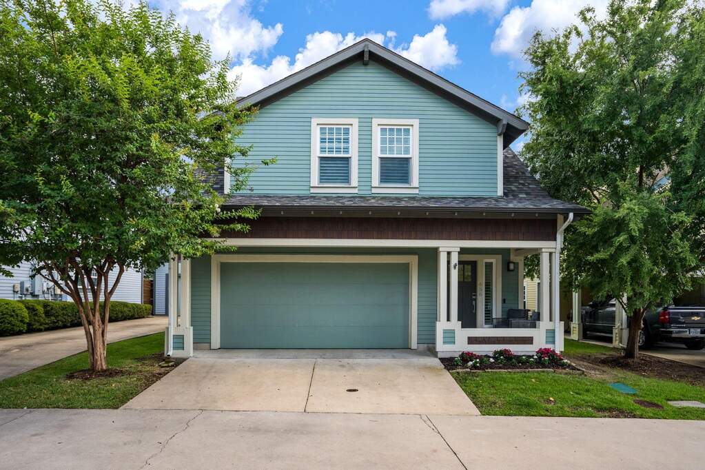 Charming Craftsman-style exterior with welcoming front porch and mature landscaping.