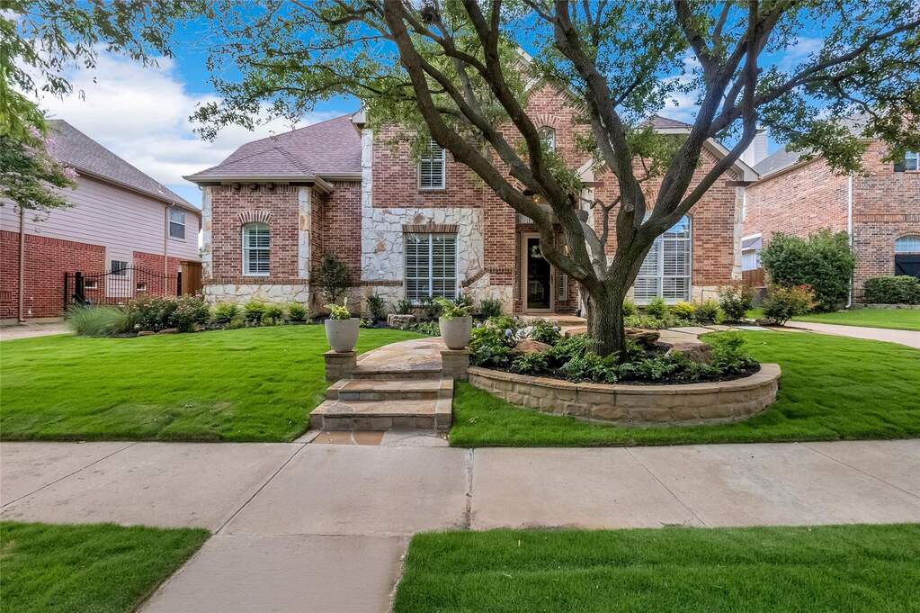 Beautifully maintained and landscaped front yard with a two-stone facade on a quiet street