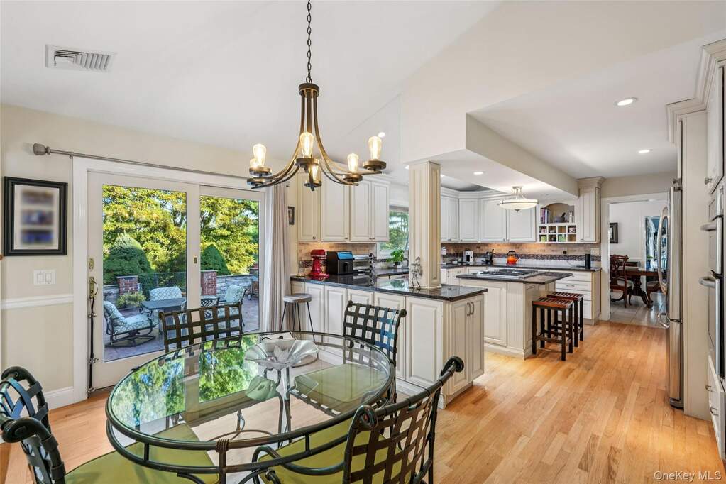 Dining room featuring light wood-style floors, a chandelier, and recessed lighting