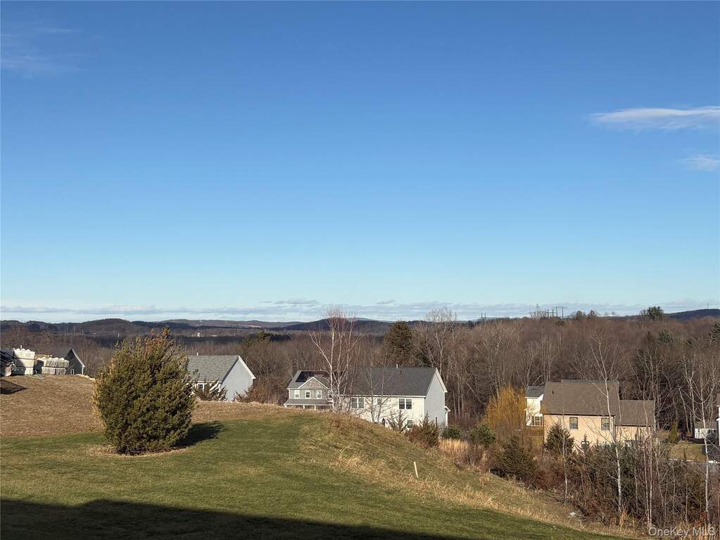 View of green lawn with a residential view
