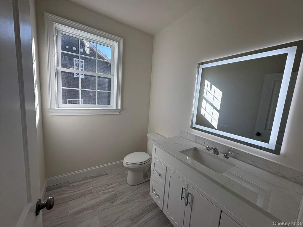 Bathroom featuring vanity and toilet