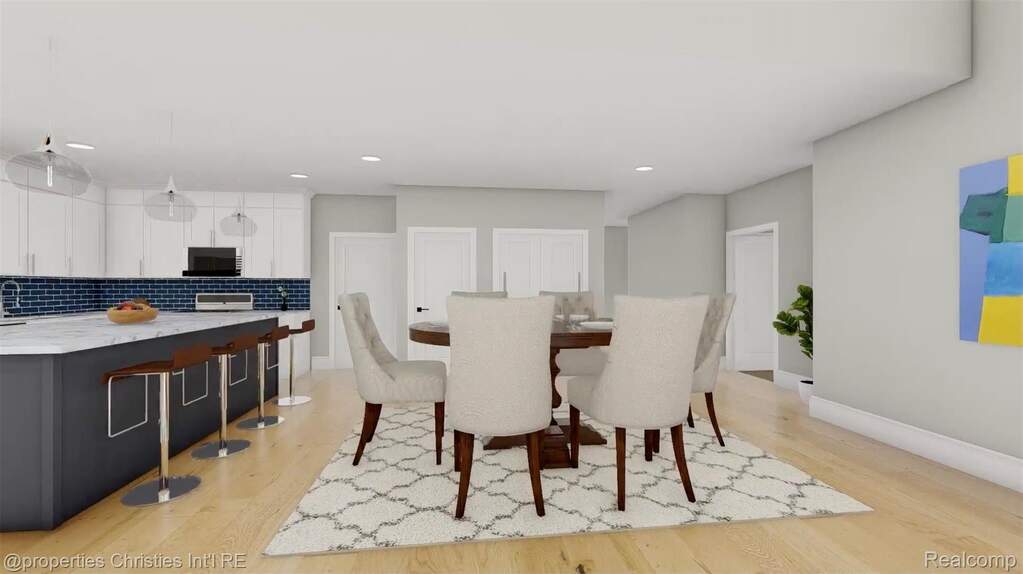 Dining room with light wood-type flooring and recessed lighting