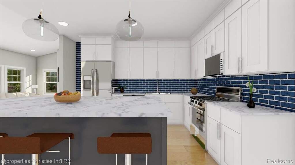 Kitchen featuring white cabinetry, stainless steel appliances, tasteful backsplash, a breakfast bar, and light stone countertops