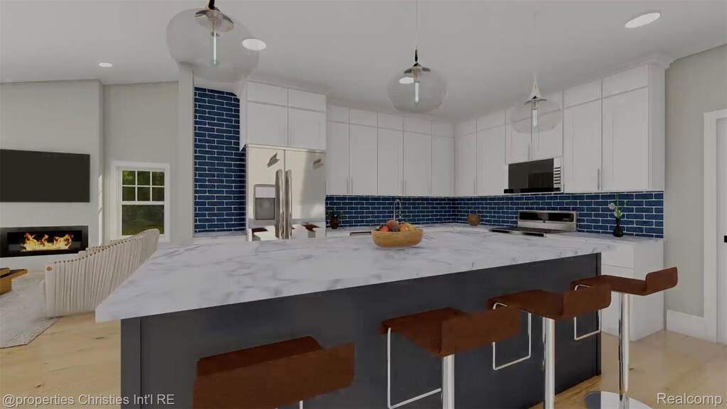 Kitchen with a breakfast bar area, appliances with stainless steel finishes, tasteful backsplash, a center island, and recessed lighting