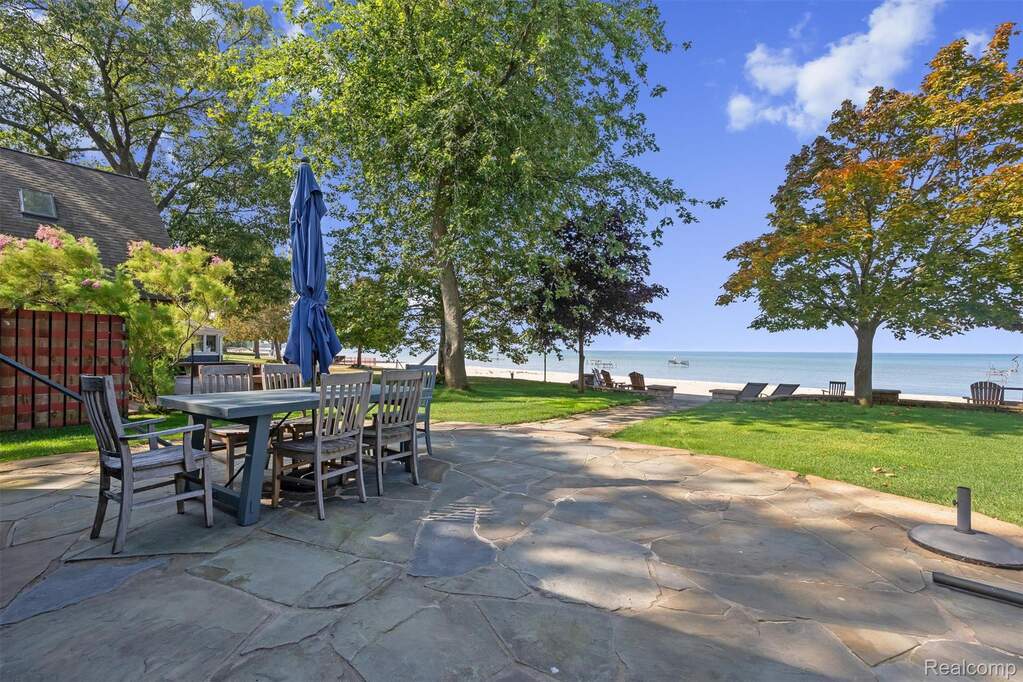 View of patio with a water view and outdoor dining area