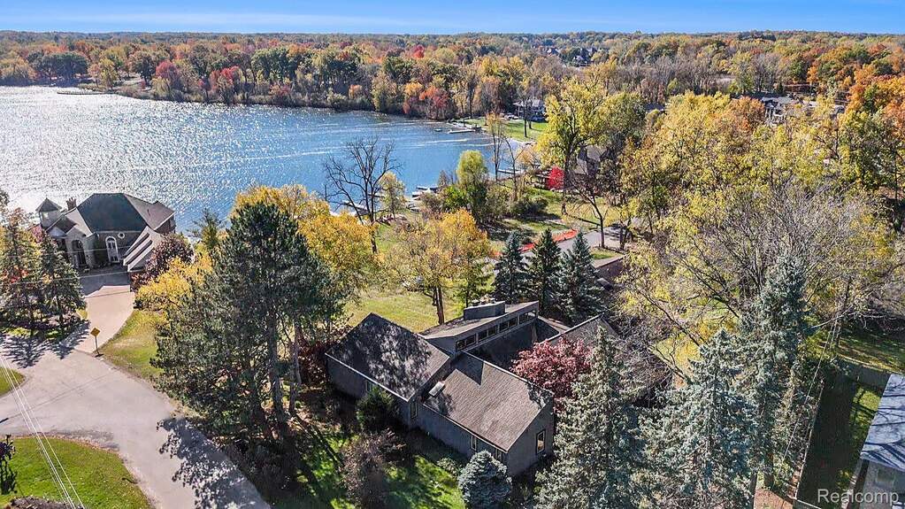 Drone / aerial view of a nearby body of water and a forest