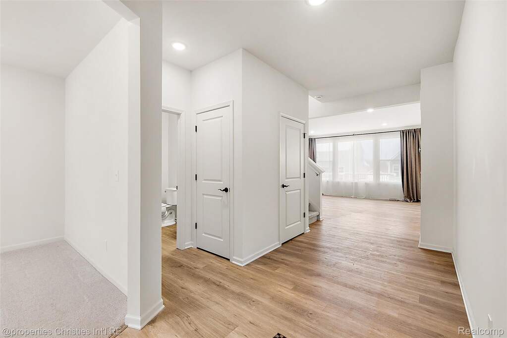 Hall featuring light wood-style flooring and recessed lighting
