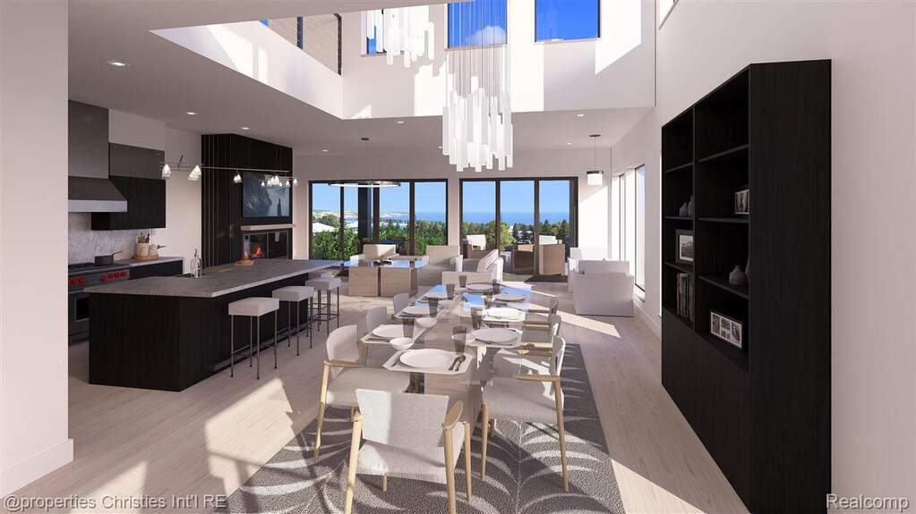 Dining space with light wood finished floors, a towering ceiling, recessed lighting, and a large fireplace