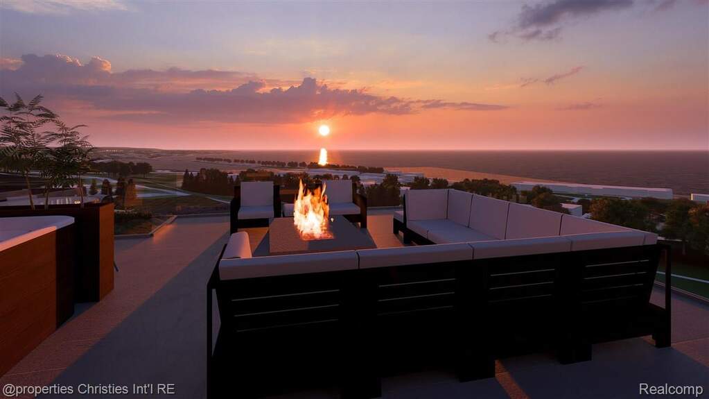 Patio terrace at dusk with a patio, a water view, and an outdoor living space with a fire pit