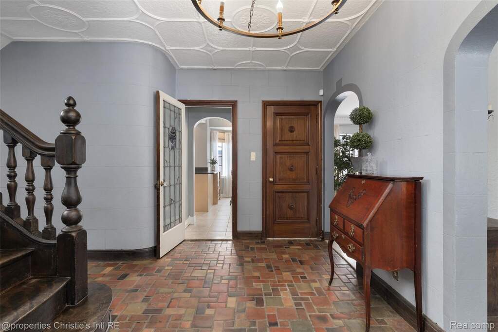 Entryway featuring stairs and arched walkways