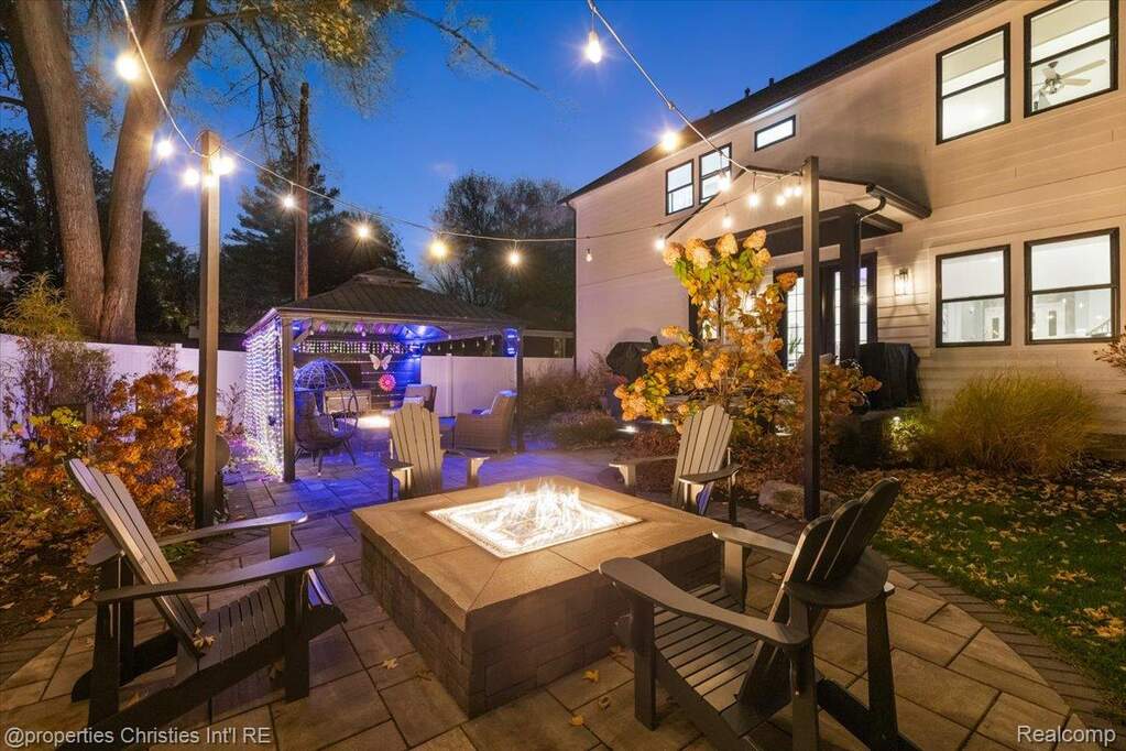 Patio at twilight with a fire pit, a gazebo, and a patio area