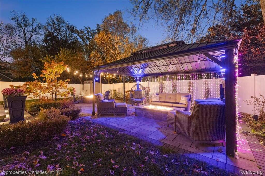 Fenced backyard featuring outdoor lounge area, a patio area, and a gazebo