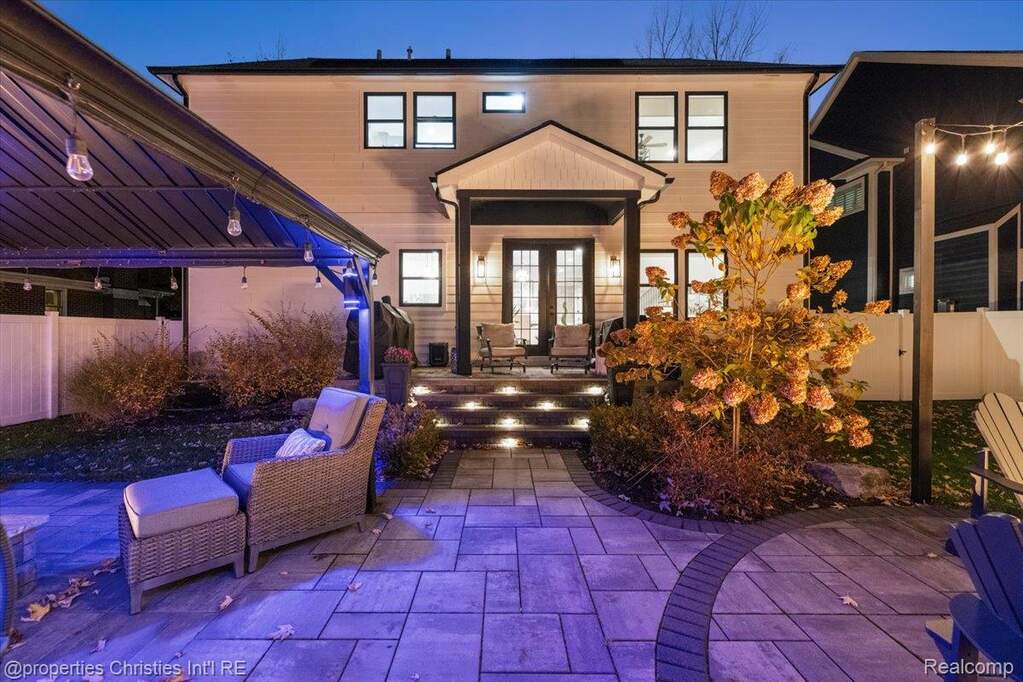 Exterior entry at twilight with a patio area and french doors
