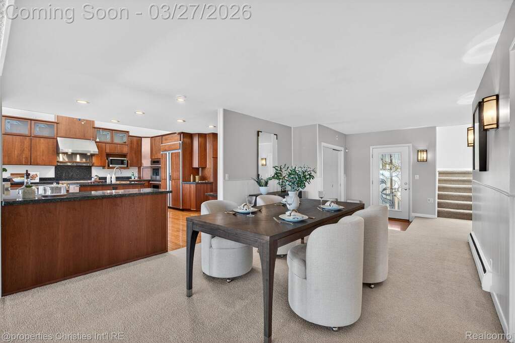 Dining space featuring light colored carpet, a baseboard heating unit, and recessed lighting