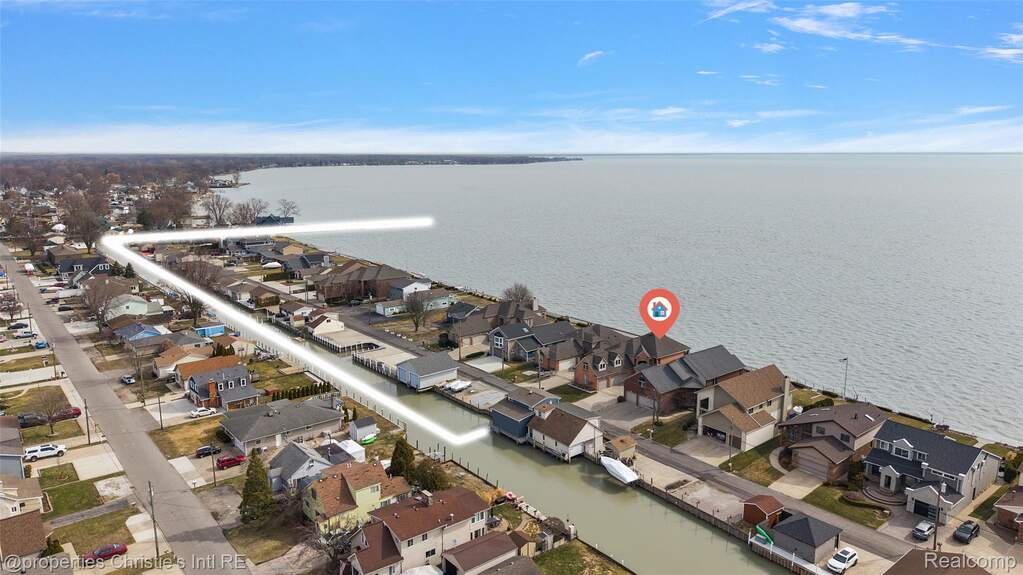 Aerial perspective of suburban area with a large body of water