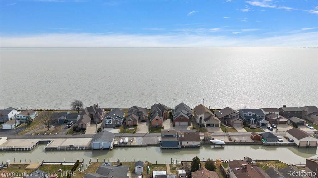 Aerial perspective of suburban area with a nearby body of water