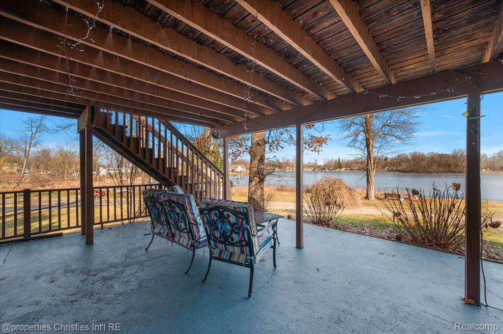 View of patio / terrace with stairway and a water view