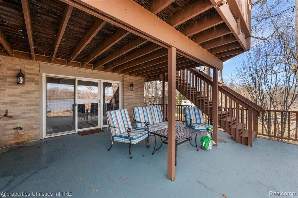 View of patio with stairs and a wooden deck