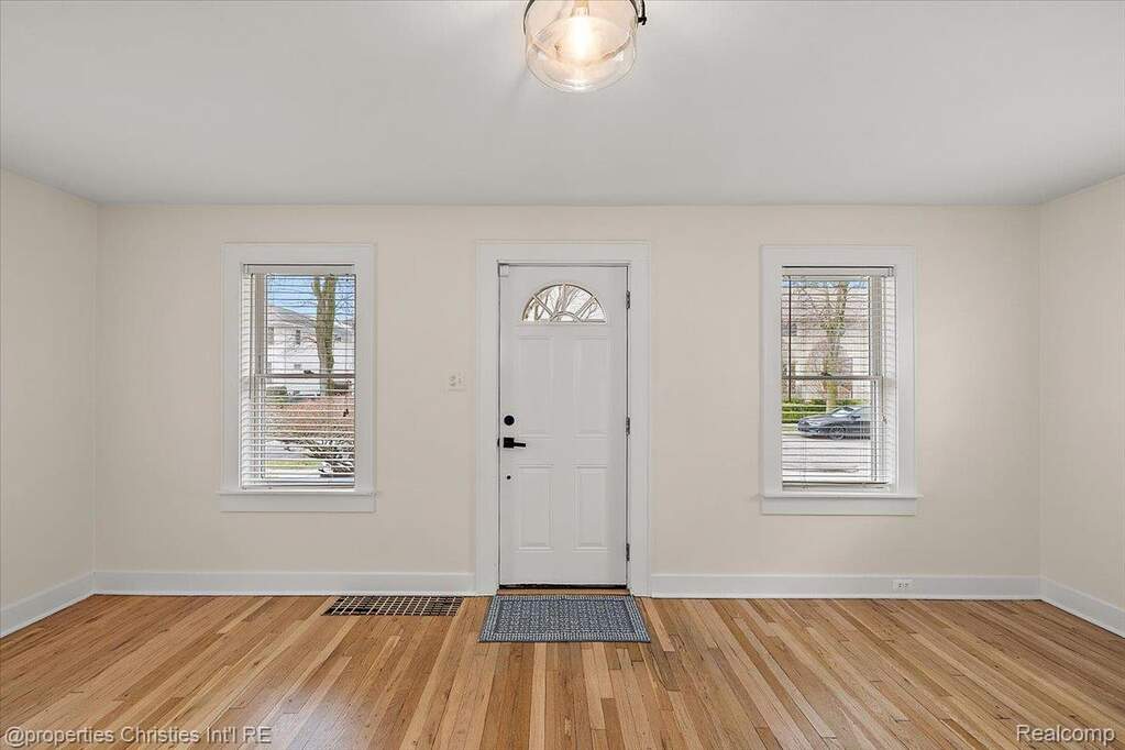 Entryway with light wood-type flooring and healthy amount of natural light