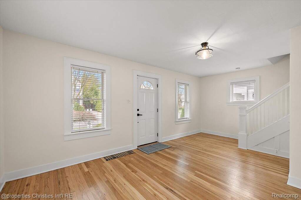Foyer with light wood-style floors and plenty of natural light