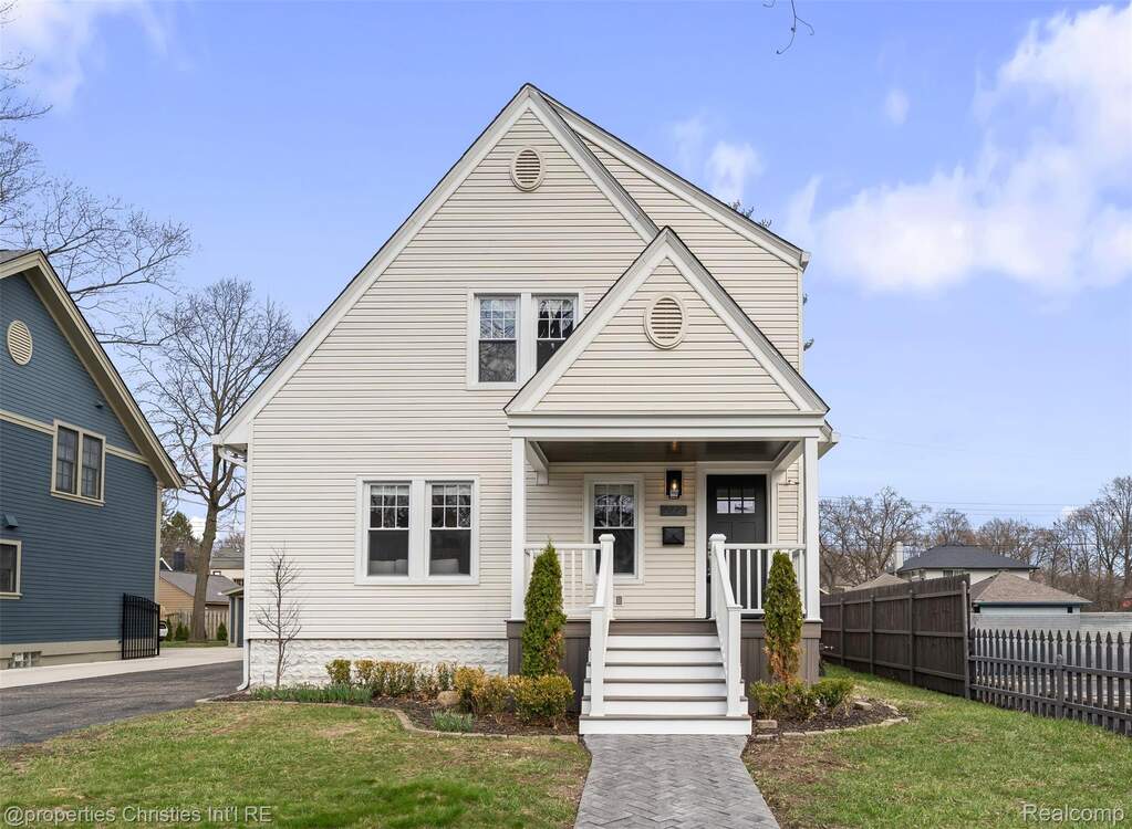 View of front facade with a front lawn and covered porch