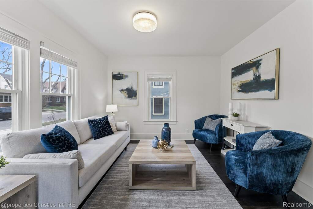 Living area featuring dark wood-type flooring and baseboards