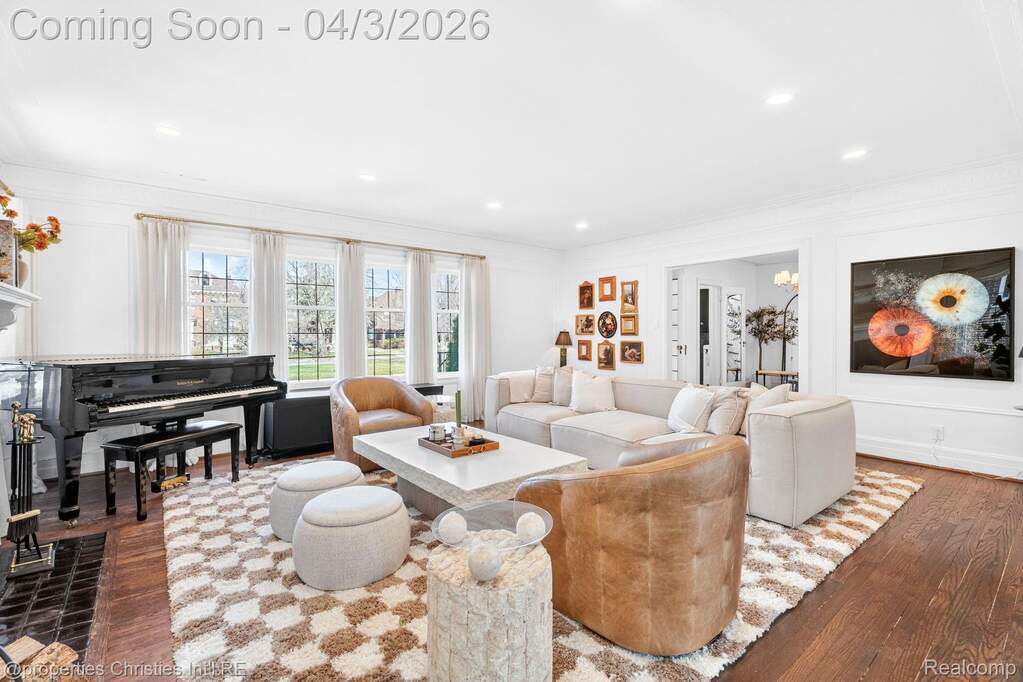 Living room featuring hardwood / wood-style floors, ornamental molding, and recessed lighting