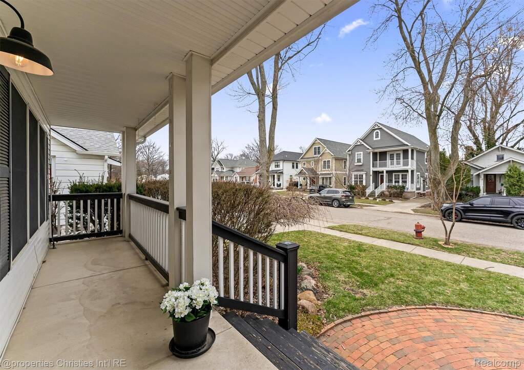 Covered porch featuring a residential view