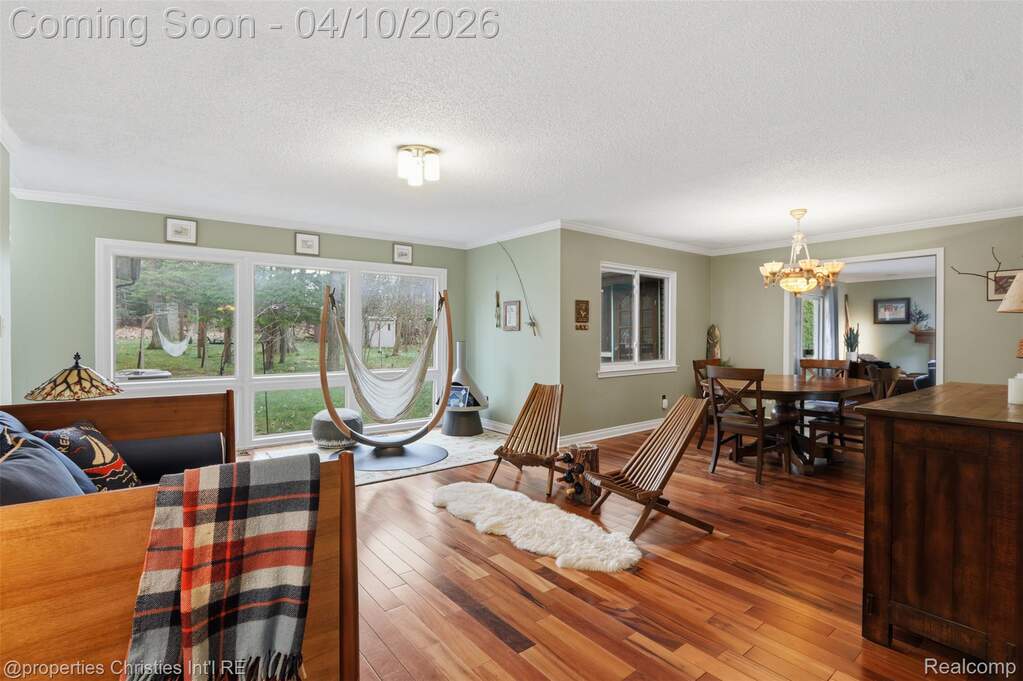 Open living space with large windows overlooking the backyard. 