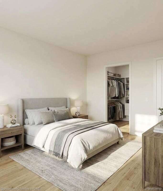 Bedroom featuring light wood-type flooring and a spacious closet