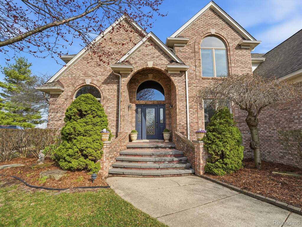 Property entrance featuring brick siding and french doors