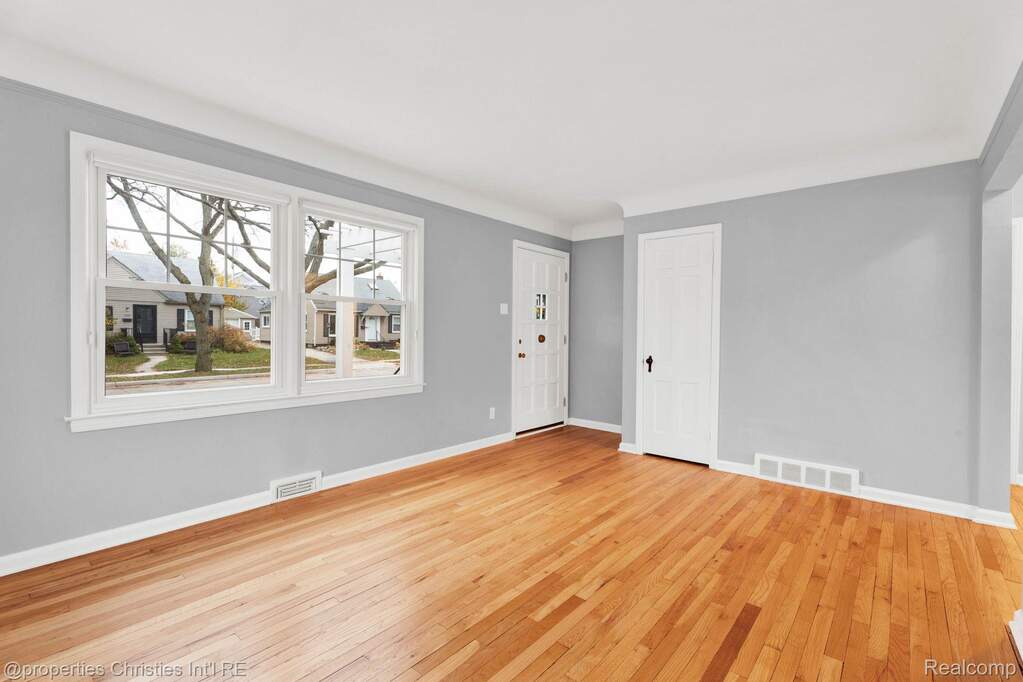 Foyer featuring light wood finished floors and baseboards