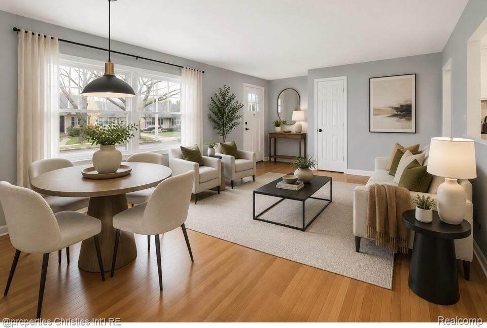 Virtual staging of living area featuring light wood-finish flooring, a large picture window, and recessed lighting