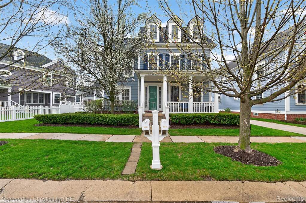 View of front of home with covered porch and a front yard