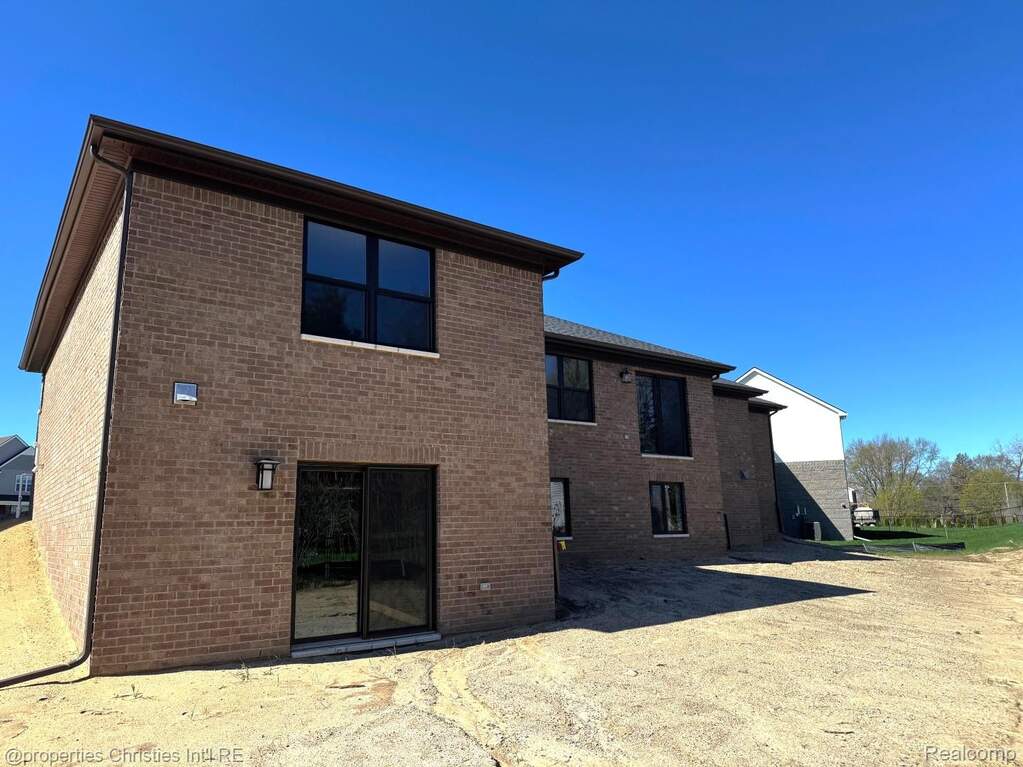Back of property featuring brick siding